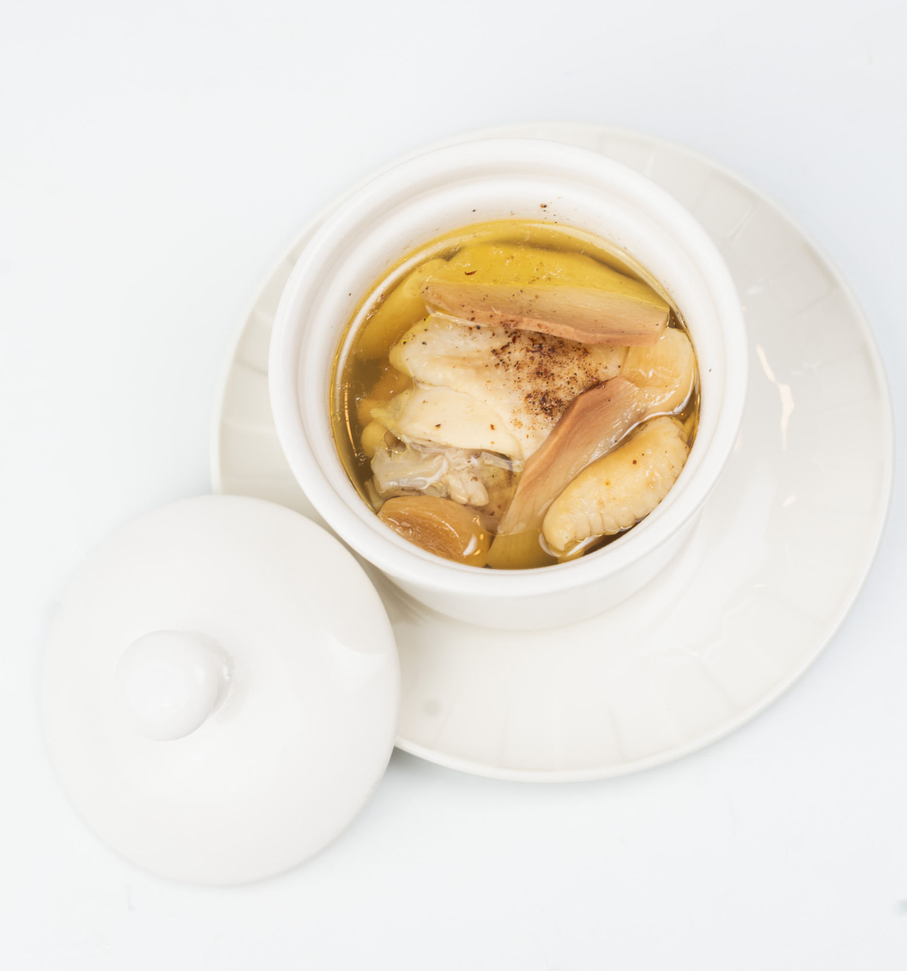 Steamed chicken soup with fresh ginger, garlic, and herbs